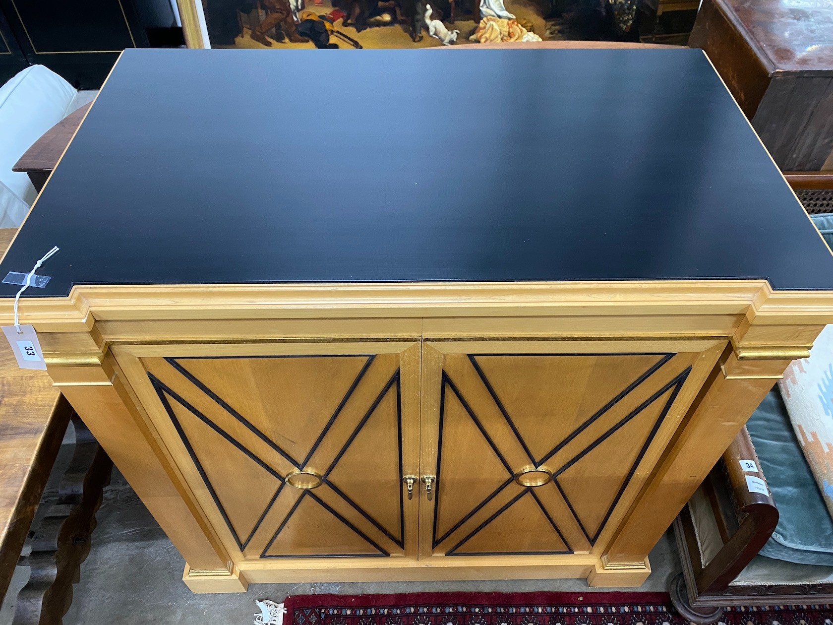 An Empire style part ebonised birch side cabinet, width 112cm, depth 64cm, height 106cm